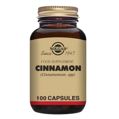 A glass bottle of Solgar cinnamon food supplements with a gold lid
