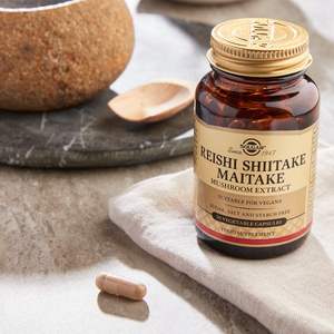 Solgar Reishi Shiitake Maitake Mushroom Extract Vegetable Capsules on a marble table