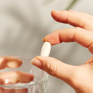 Solgar Vitamin C 1500 mg with Rose Hips tablets in a person's hand