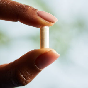 Solgar Biotin supplement in a person's hand