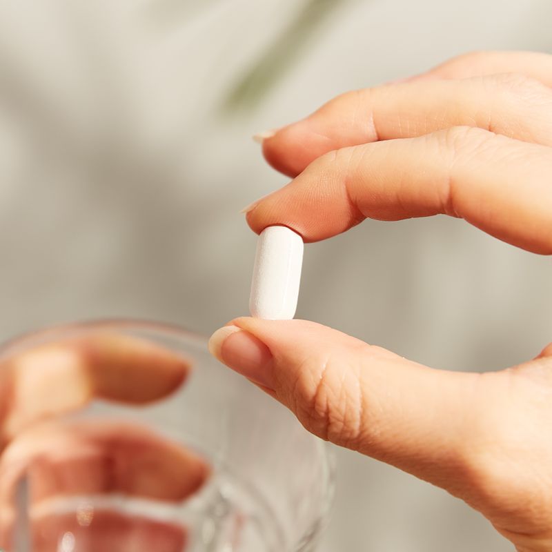 Solgar Calcium Magnesium Plus Zinc supplement in a person's hand