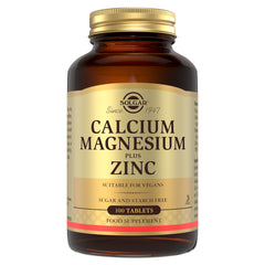 Solgar Calcium Magnesium Plus Zinc supplements in a glass bottle with a gold lid