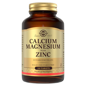 Solgar Calcium Magnesium Plus Zinc supplements in a glass bottle with a gold lid