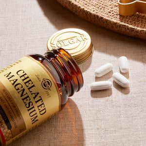 Solgar Chelated Magnesium supplements in a glass bottle on a table