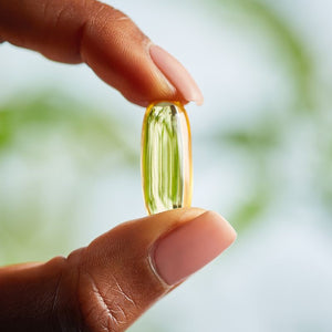 Solgar fish gel omega 3 softgels in a person's hand