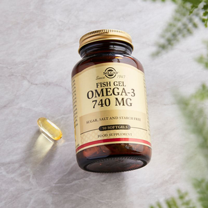 Solgar Fish Gel Omega-3 740 mg Softgels in a glass jar on a table
