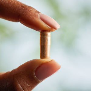 Solgar Green Tea Leaf Extract vegetable capsule in a person's hand