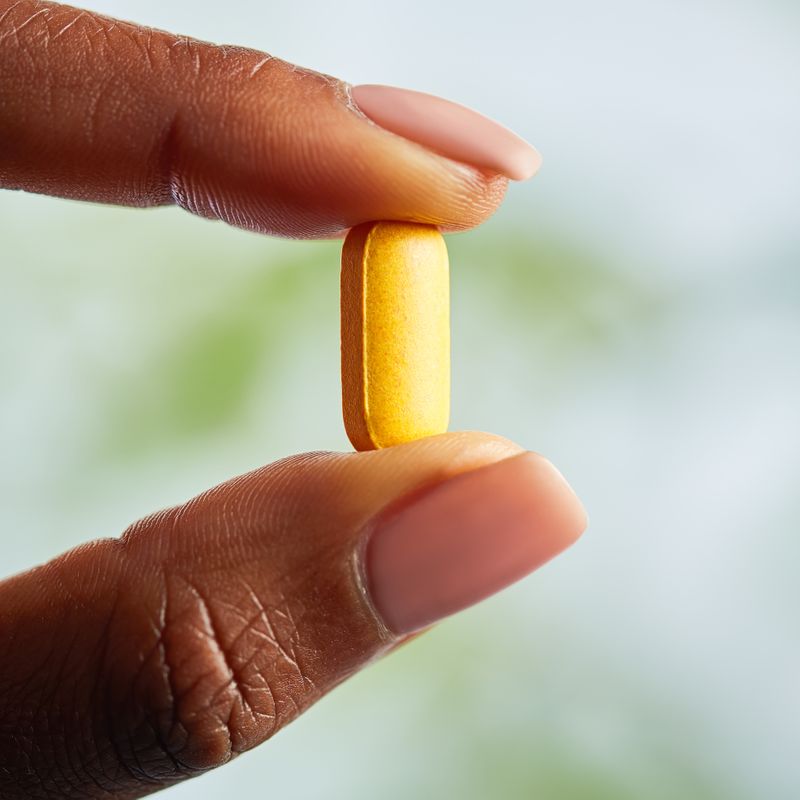 Solgar Megasorb Vitamin B-Complex High Potency Tablet in a person's hand