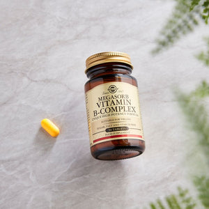 Solgar Megasorb Vitamin B-Complex High Potency Tablets in a glass jar on a table