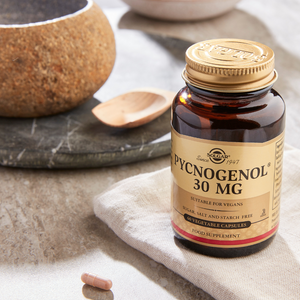 Solgar Pycnogenol 30 mg Vegetable Capsules in a glass jar on a marble table