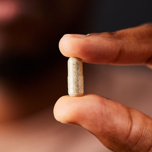 Solgar Saw Palmetto Berries vegetable capsule in a person's hand