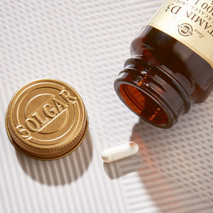 Solgar Vitamin D3 supplements in a glass bottle on a table