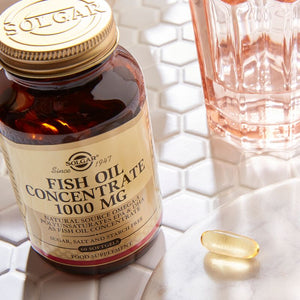 Solgar Fish Oil Concentrate 1000 mg softgels on a marble table