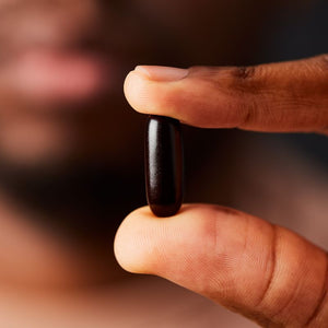 Solgar Ester-C Plus Immune Complex Softgel in a person's hand