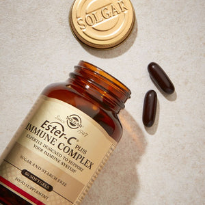 Solgar Ester-C Plus Immune Complex Softgels in a glass jar on a table