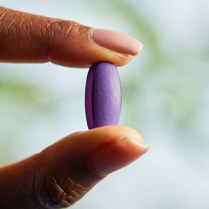 Solgar VM-Prime for Women multivitamin tablet in a person's hand