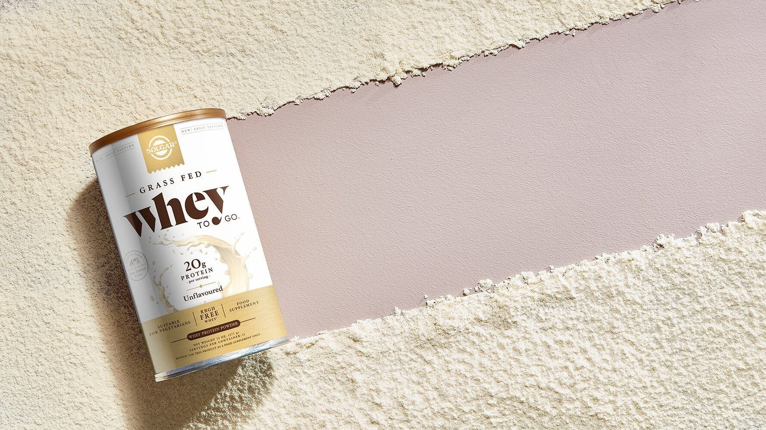 Solgar Grass Fed Whey To Go Protein Powder on a pink surface