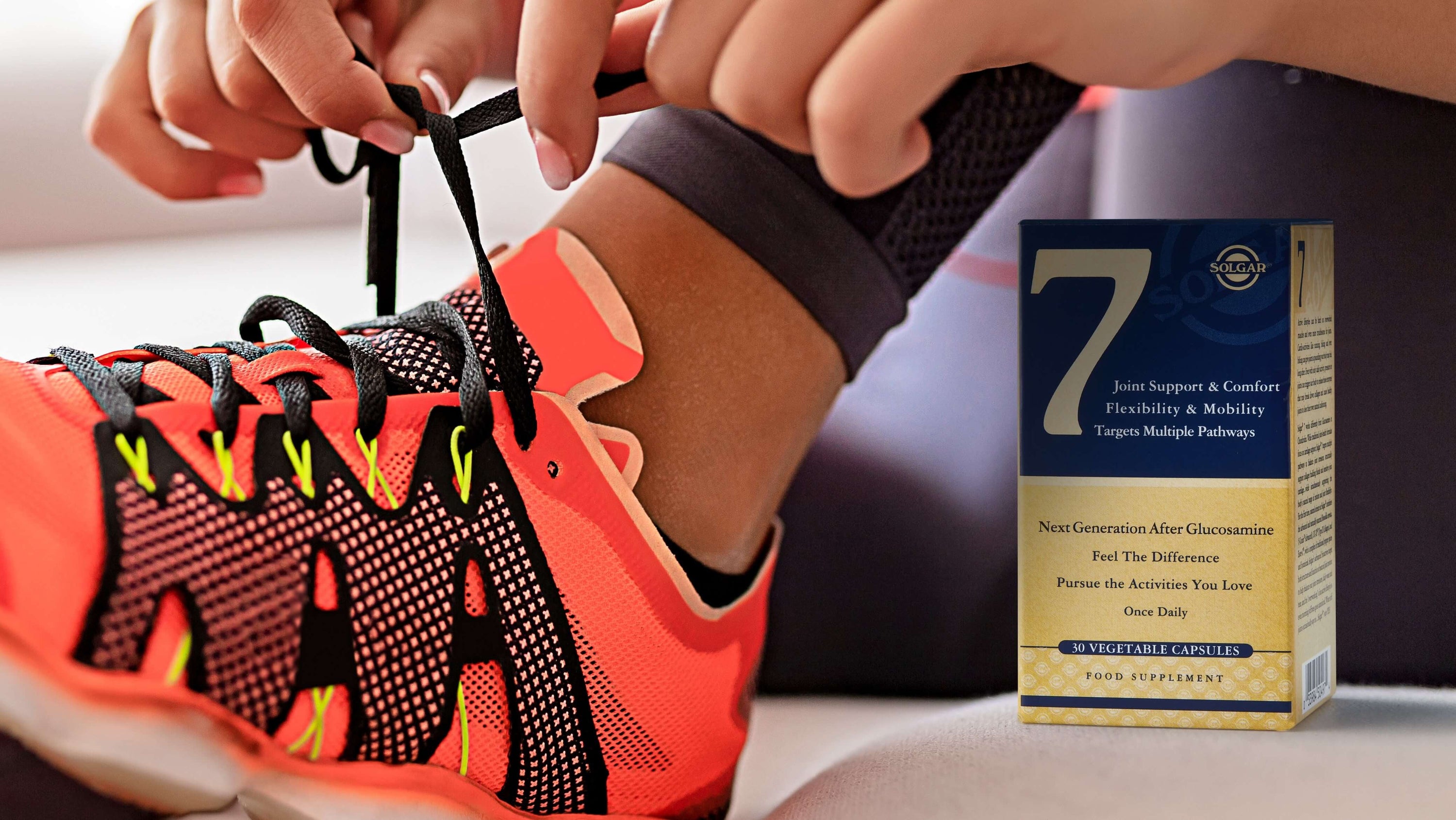 Woman putting trainers on to exercise after taking her Solgar 7 supplements. 