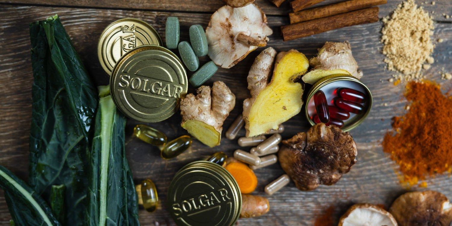 Solgar gold lids on a wooden table beside foods to support immune health