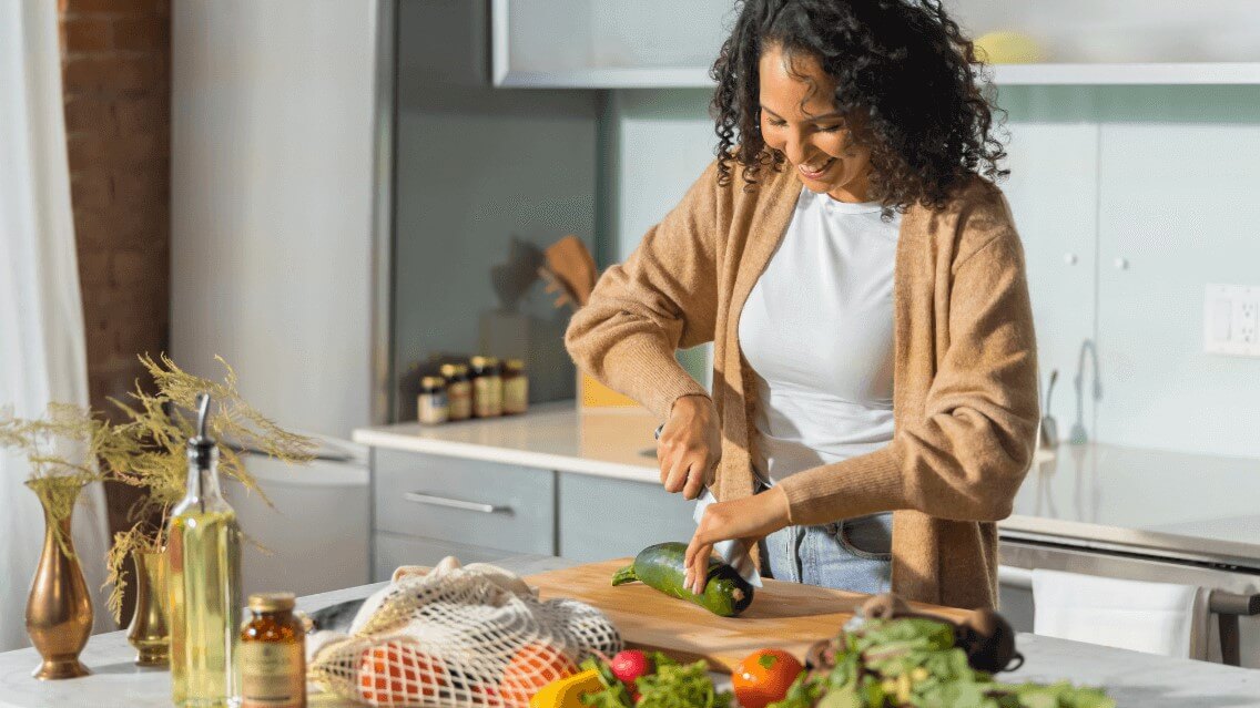 Woman in her kitchen cooking a healthy, nutritious meal