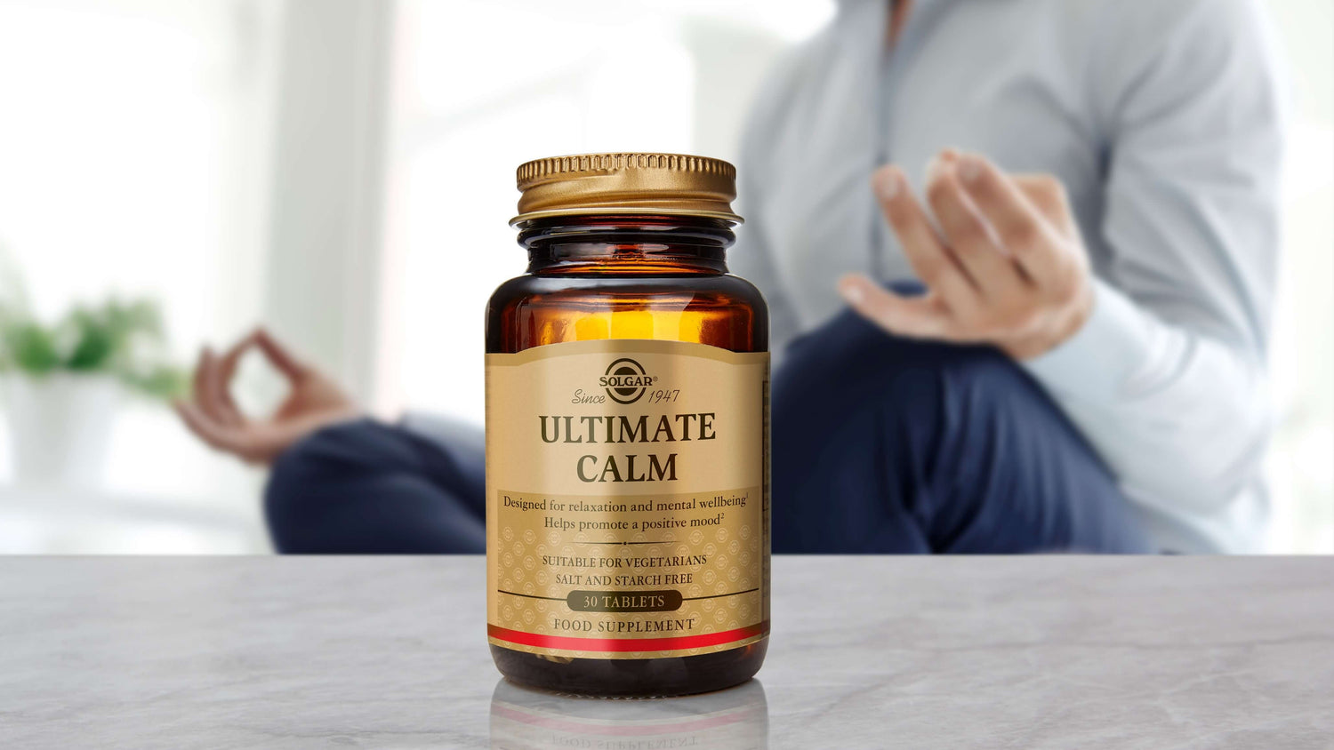 A woman meditating next to her Solgar Calm nutrients 