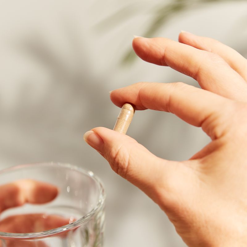 Solgar Deglycyrrhised Licorice Root Extract vegetable capsule in a person's hand