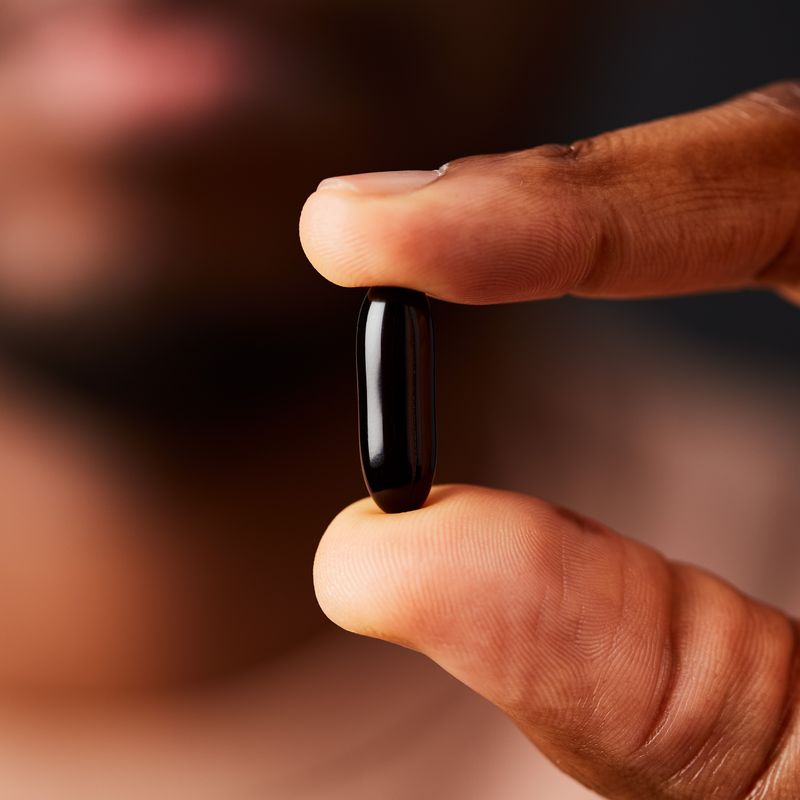 Solgar Phytosterol Complex softgels in a person's hand