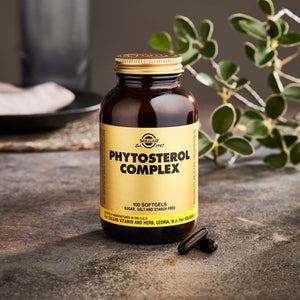 Solgar Phytosterol Complex softgels in a glass jar on a stone table