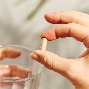Solgar Reishi Shiitake Maitake Mushroom Extract Vegetable Capsules in a person's hand