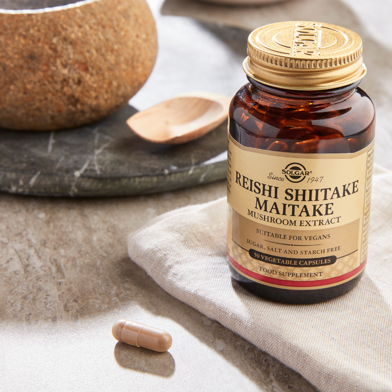 Solgar Reishi Shiitake Maitake Mushroom Extract Vegetable Capsules on a marble table
