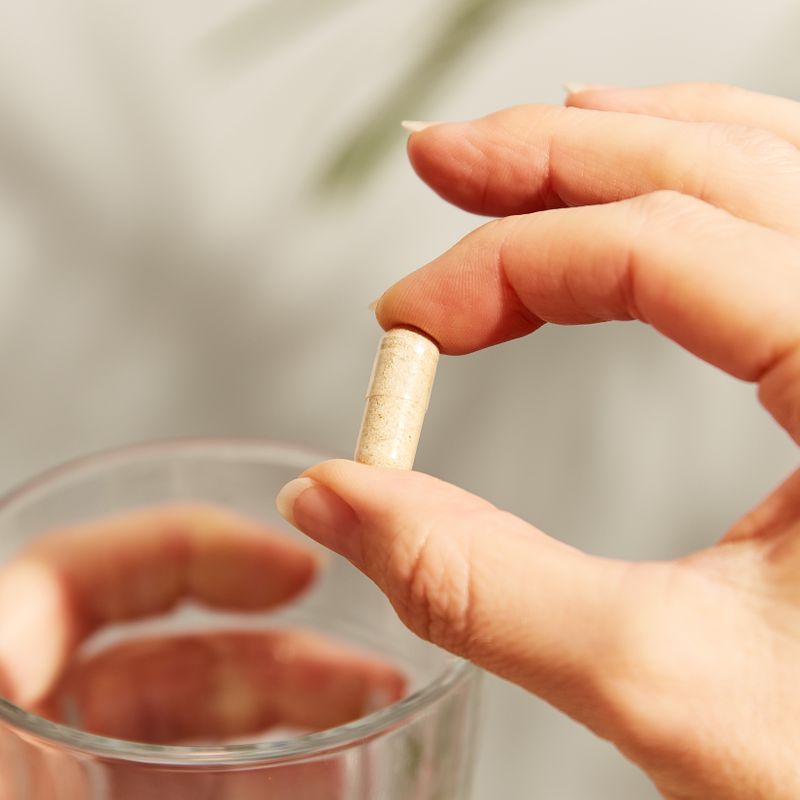 Solgar Advanced Multi-Enzyme Complex vegetable capsule in a person's hand 