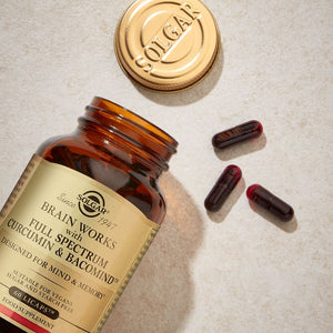 Solgar Brain Works with Full Spectrum Curcumin Capsules in a glass jar on a table 