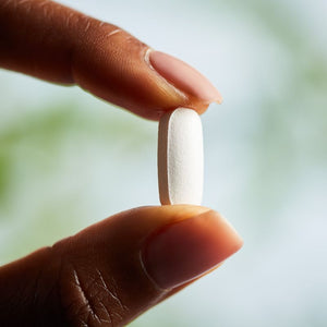 Solgar Chelated Magnesium supplement in a person's hand