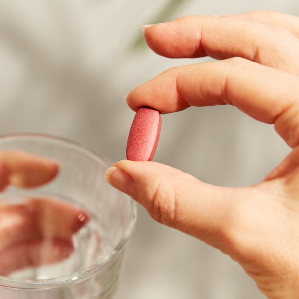 Solgar Collagen Hyaluronic Acid Complex supplement in a person's hand