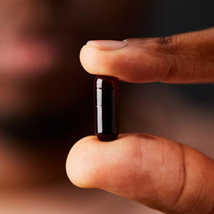 Solgar Full Spectrum Curcumin capsule in a person's hand