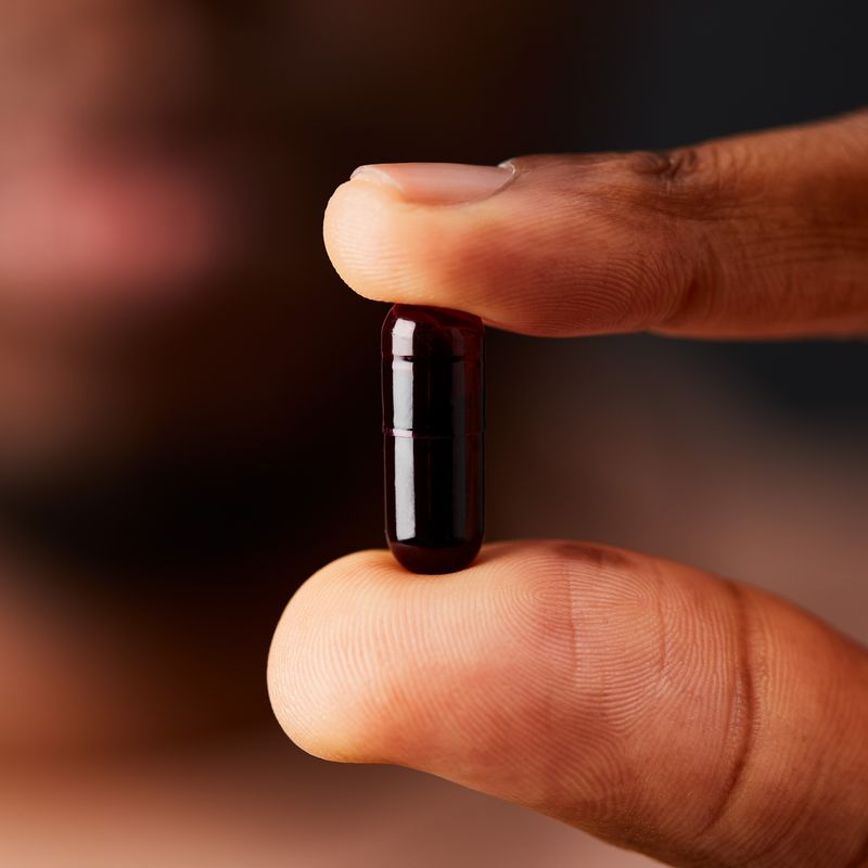 Solgar Full Spectrum Curcumin capsule in a person's hand