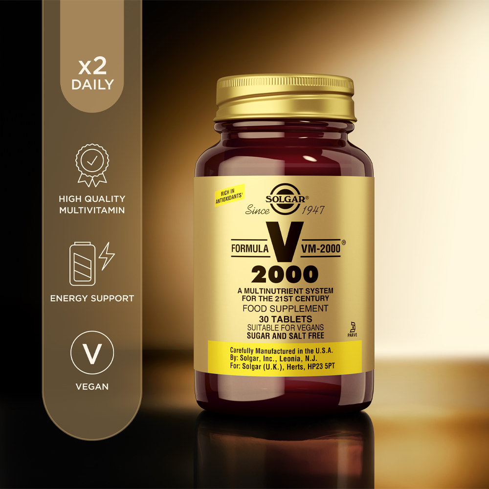 Solgar Formula VM-2000 Multivitamin Tablets in a glass jar with product information beside