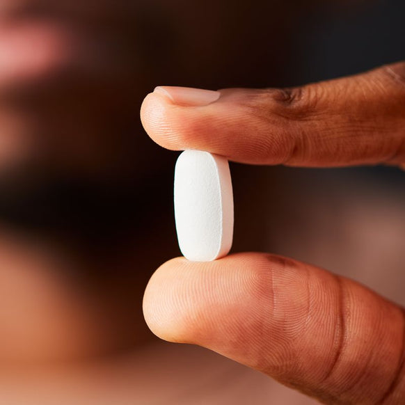 Solgar Magnesium Citrate supplement in a person's hand