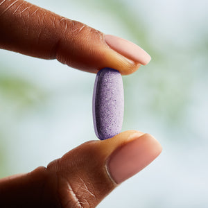 Solgar multi one tablets in a person's hand