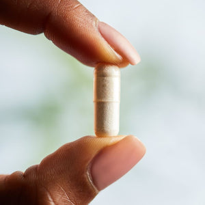 Solgar Natural Vitamin K2 MK-7 from Natto Extract vegetable capsule in a person's hand