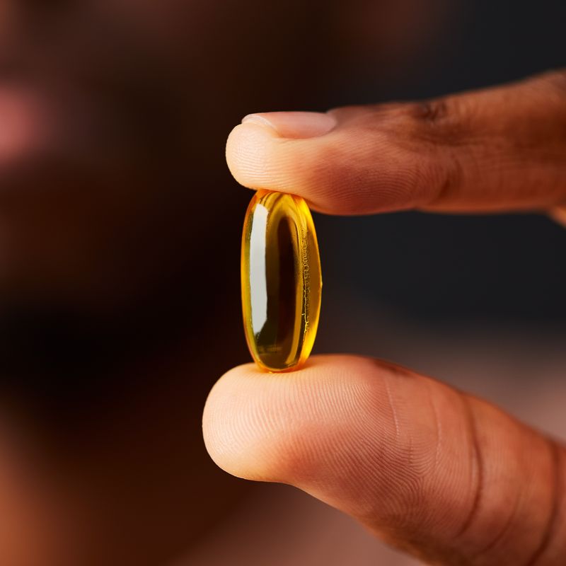 Solgar Omega 3-6-9 Fish Oil supplement in a person's hand