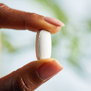 Solgar Ultimate Bone Support supplement in a person's hand 