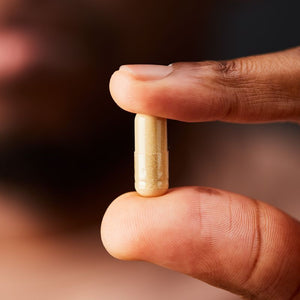 Solgar Ultimate Calm daily support capsules in a person's hand