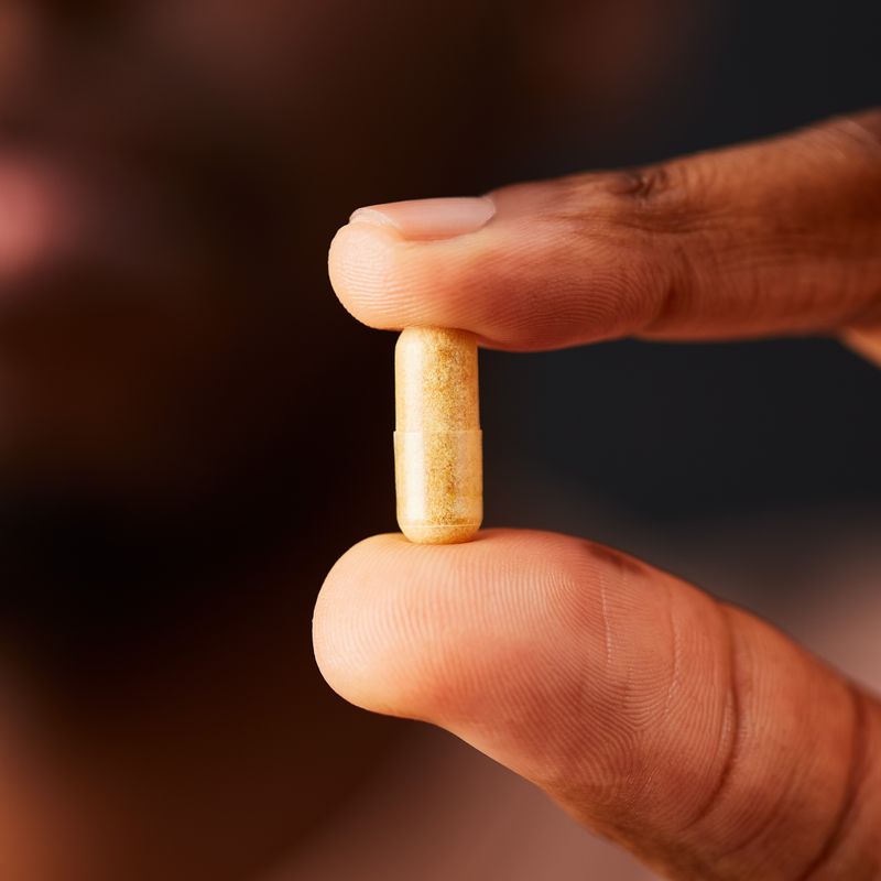 Solgar Vitamin B-complex supplement in a person's hand