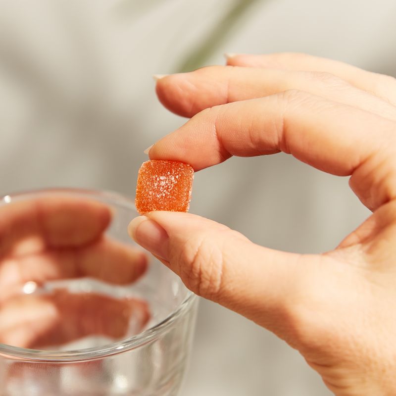 Solgar U-Cubes Children's Multi-Vitamin and Mineral Gummies in a person's hand