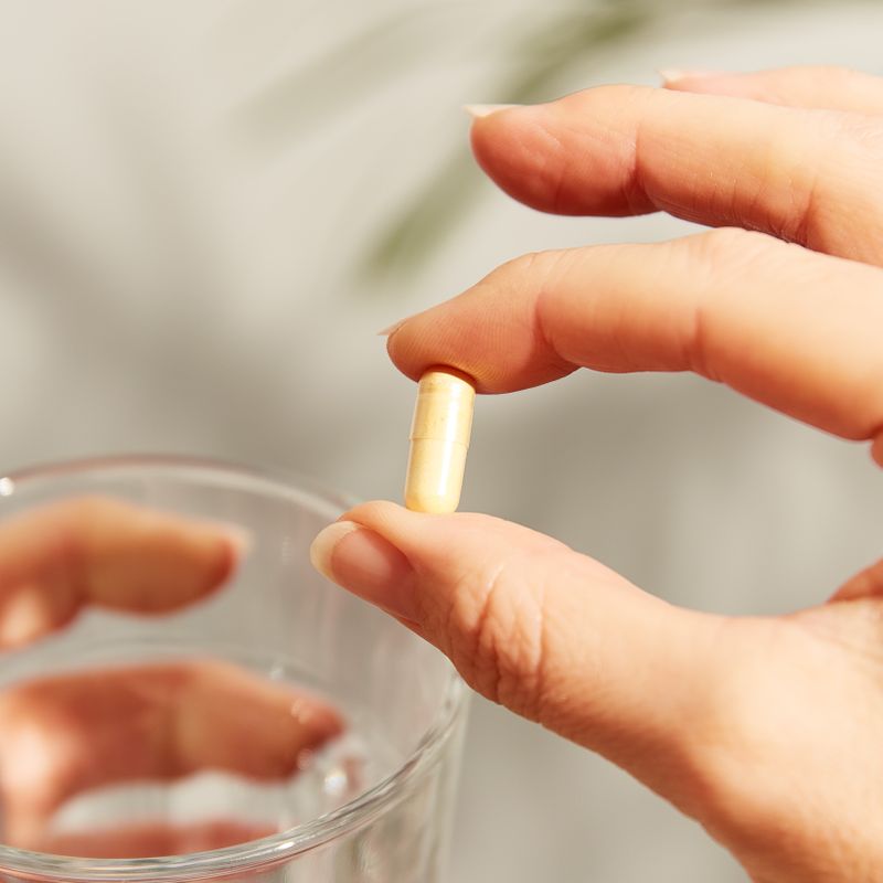 Solgar CoQ-10 30mg capsules in a person's hand