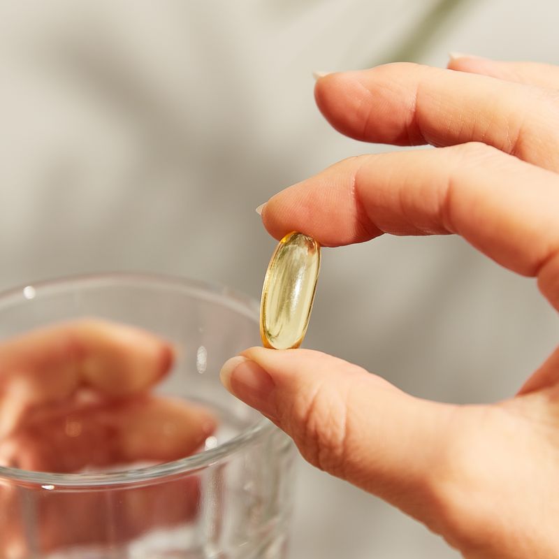 Solgar Fish Oil Concentrate 1000 mg softgels in a person's hand