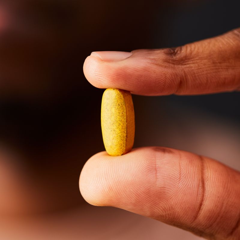 Solgar Formula VM-2000 Multivitamin Tablet in a person's hand