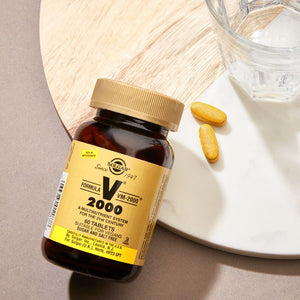 Solgar Formula VM-2000 Multivitamin Tablets in a glass jar on a table