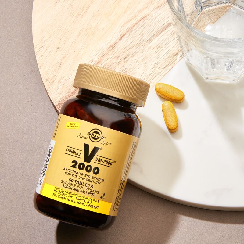 Solgar Formula VM-2000 Multivitamin Tablets in a glass jar on a table